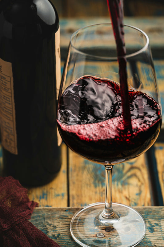 Red wine being poured into a glass