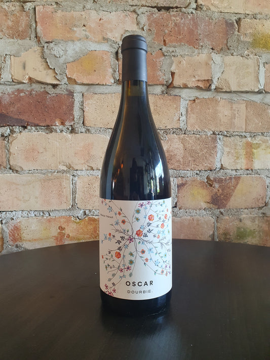 Wine bottle with decorative label on a brick surface