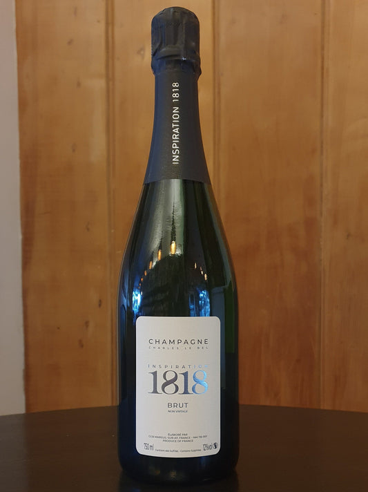 Bottle of 1818 champagne on a wooden surface