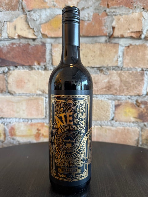Wine bottle with decorative label on a brick background