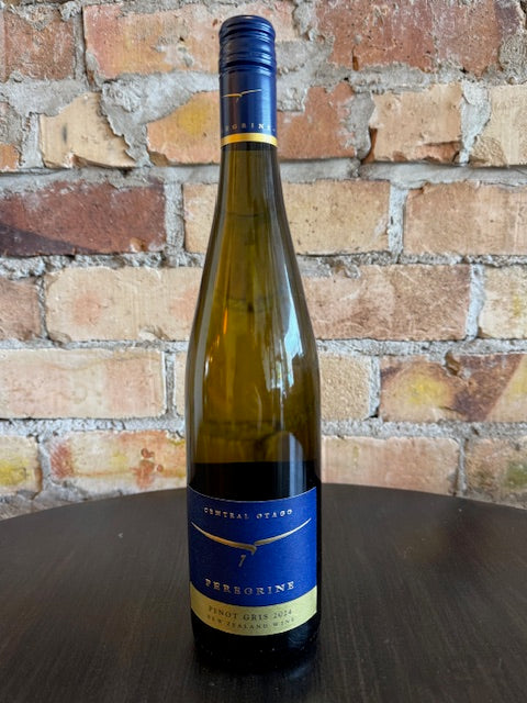 Wine bottle with blue label and image of a Peregrine bird in front of a brick surface